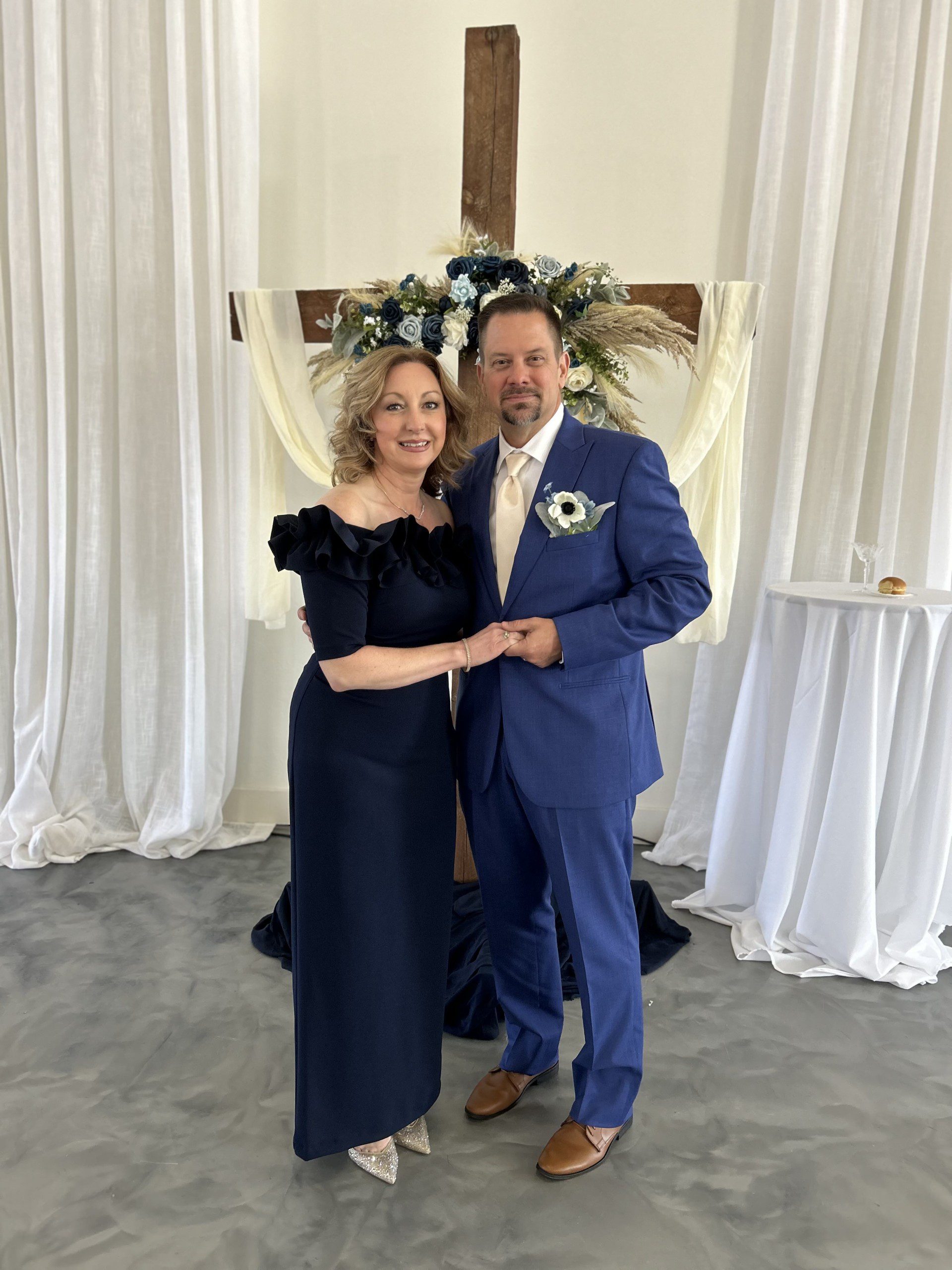a couple posing for a photo at a ceremony